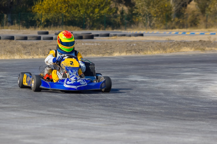 Kart driver with helmet on a kart track