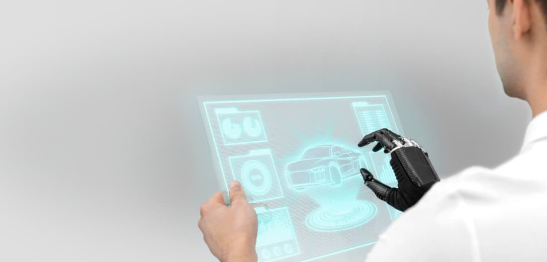 Engineer with a bionic glove interacting with a holographic car display