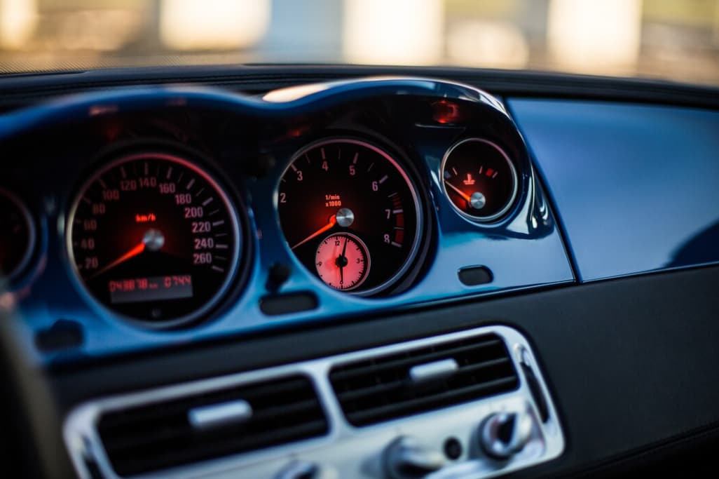 Close-up of a car's dashboard displaying the tachometer and speedometer