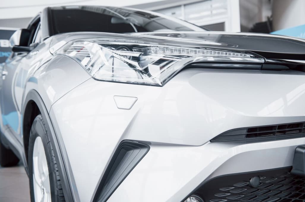Close-up view of a modern car's headlight and front grille